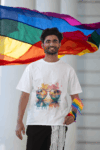 blinkstore-t-shirt-mockup-featuring-a-smiling-bearded-man-posing-against-a-pride-flag-m39092_optimized_250