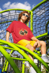 oversized-t-shirt-mockup-featuring-a-man-smiling-in-a-playground-game-m53349_2_optimized_100