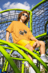 oversized-t-shirt-mockup-featuring-a-man-smiling-in-a-playground-game-m53349_4_optimized_100